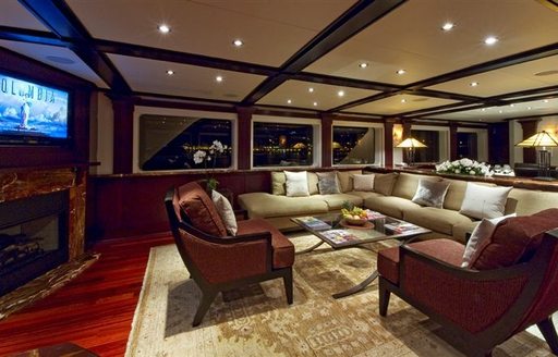 luxury motor yacht L'ALBATROS main salon with audio-visual system and fireplace