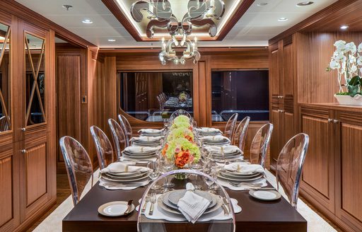 formal dining area clad in Peruvian walnut on board charter yacht Endless Summer