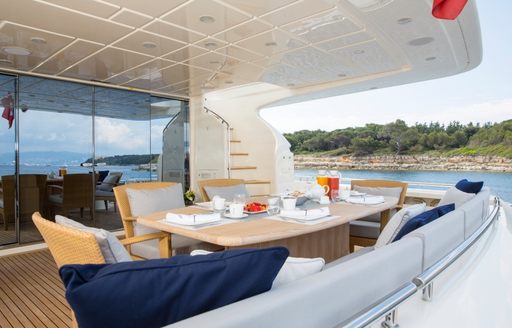 table and chairs on the aft deck of luxury yacht Porthos Sans Abri 