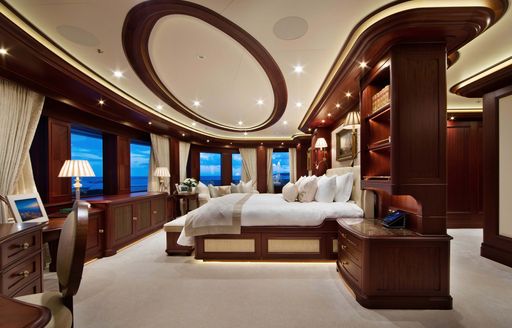 Overview of the master cabin onboard private charter yacht GIGIA, central berth facing forward with multiple windows