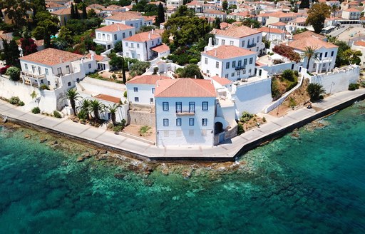 Town on the waterfront in Greece, with mansions lined up opposite the sea