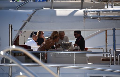 people socialising on board a luxury superyacht at the Grand Prix
