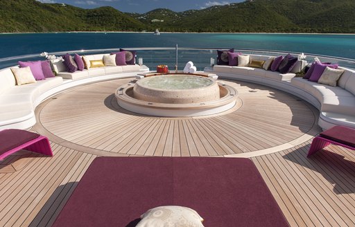 Jacuzzi surrounded by sun pads on sun deck of charter yacht Solandge