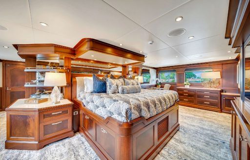 Master cabin onboard charter yacht VALHALLA, central elevated berth with ample storage surrounding.