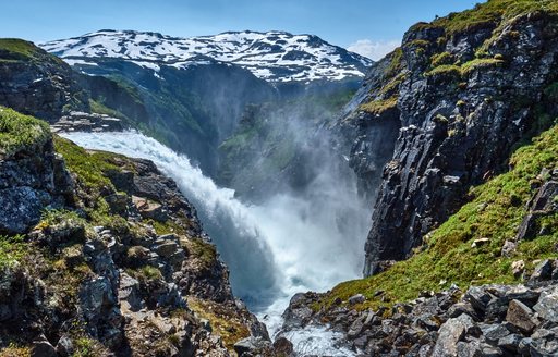 Mighty Dronningstien waterfall in the high mountains between Kinsarvik and Lofthus, Norway 