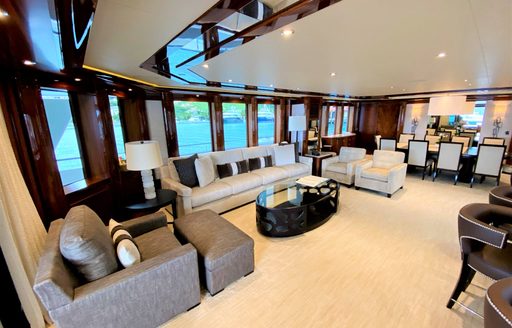 Large lounge area with tables, sofas and armchairs on superyacht Chasing Daylight