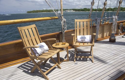 deck chairs and table with drinks on aboard luxury yacht EROS