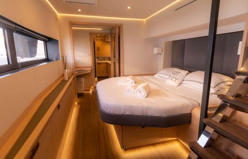 Master cabin onboard charter yacht SERENISSIMA III, central berth facing port with windows directly opposite