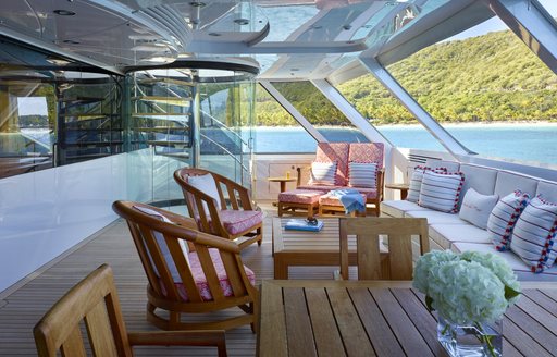 private terrace which adjoins master suite with huge windows and seating on board charter yacht ‘Victoria del Mar’ 