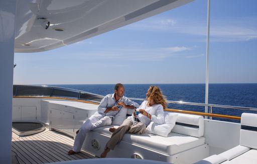 charter guests relaxing on sundeck of motor yacht L’Albatros