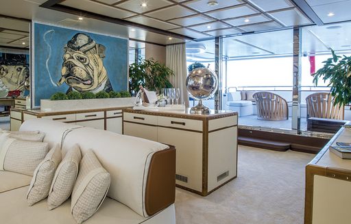Skylounge of yacht Soy Amor, with views over alfresco dining area and quirky dining set up on aft deck