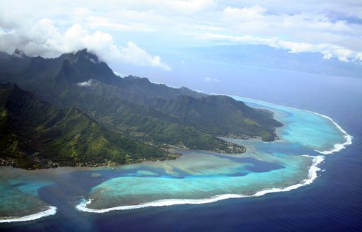 Aerial view of islands ringed by coral reef in Tahiti