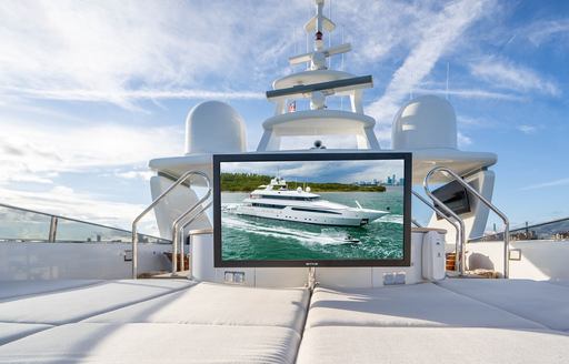 Overview of the outdoor cinema onboard charter yacht ARTEMISEA, large screen elevated over spacious sunpads