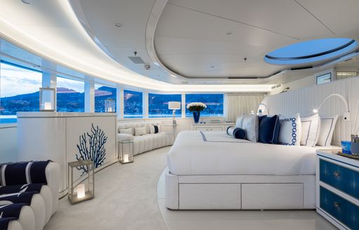 Master cabin onboard superyacht charter CORAL OCEAN, central berth facing port, surrounded by windows