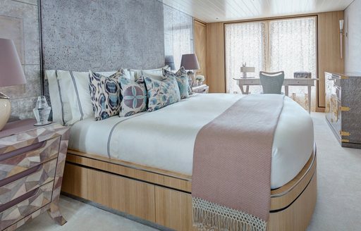 minimalist and stylish VIP cabin with pink accents and rich sophisticated tone in mega yacht JOY