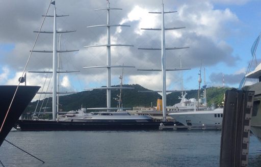 three masts of super yacht Maltese Falcon stand out in Falmouth Harbour Marina at the 2016 Antigua Charter Show