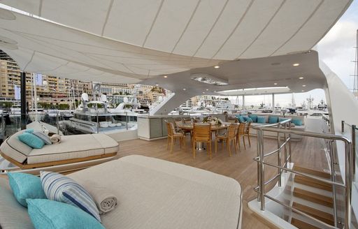 oversized sunpads and dining area on the sundeck of luxury yacht SCORPION 