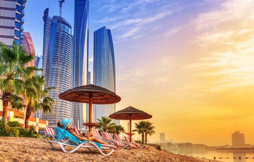 Lady sunbathing at a beach in Dubai