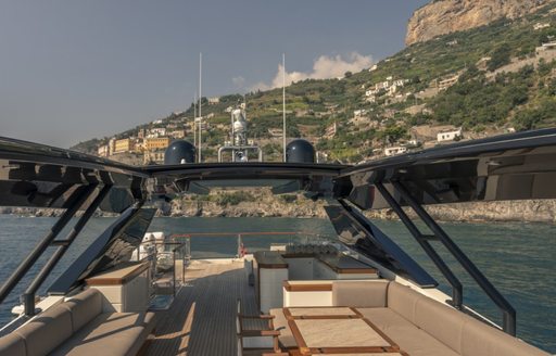 Sundeck of motor yacht VIVALDI, with seating areas and views of Mediterranean in background