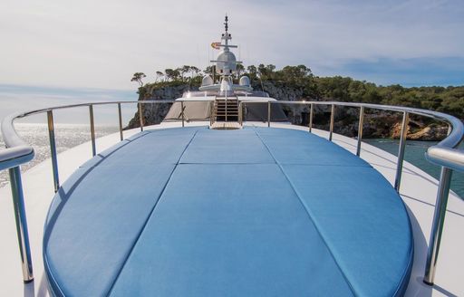 blue sunpads on the foredeck of motor yacht benita blue with wheelhouse in background