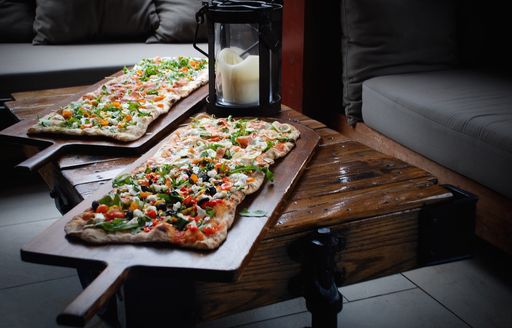 Pizza presented on a wooden chopping board