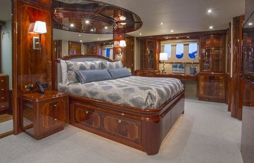 master suite on board luxury yacht ‘Gale Winds’  with high gloss woodwork and light furnishings