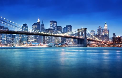 New York skyline with river and bridge at night