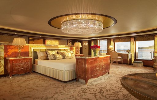 sophisticated master suite on board superyacht SOLANDGE with glittering chandelier