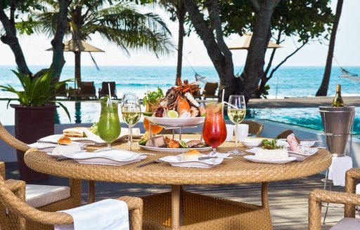 Lunch set up by pool in the Caribbean overlooking the beach