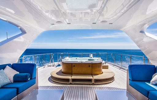 Luxury yacht LULU sundeck, with jacuzzi pool and blue sofa seating