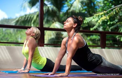 two women doing yoga at the marigot bay resort and spa hotel 
