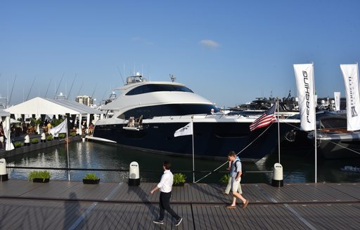 guests looking at an awe inspiring superyacht that is berthed at the miami yacht show 2020