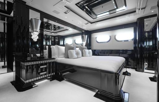 Overview of the master cabin onboard charter yacht SILVER ANGEL, central berth with two windows in the background