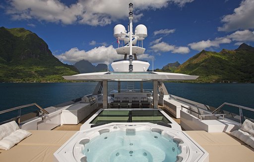 Jacuzzi, sunpads and dining area on board sundeck of luxury yacht ‘Big Fish’ 