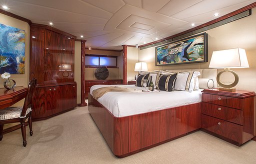 master suite with neutral furnishings and rich woods aboard charter yacht ‘Sweet Escape’ 