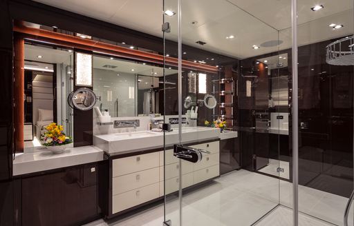 Private bathroom for the master cabin onboard charter yacht AQUA LIBRA, with shower cubicle in foreground and spacious sink unit adjacent