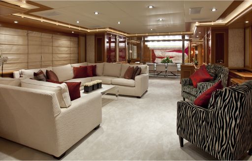lounge with cream sofa and zebra-print armchairs on board superyacht EMOTION