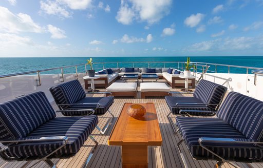 Sun deck onboard charter yacht HALO with alfresco lounge area forward