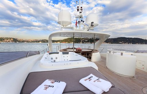sun pads, Jacuzzi and dining area beyond on sundeck of charter yacht CANPARK 