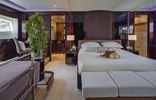 master suite with bed and raised lounge area on board motor yacht ‘My Toy’