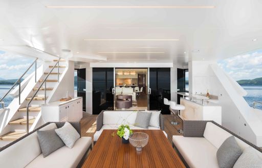 Overview of the main deck aft onboard charter yacht FREEDOM, alfresco lounge and dining area visible