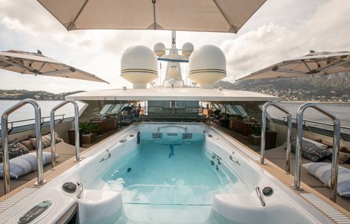 Swimming pool onboard charter yacht ARBEMA, surrounded by sun pads 