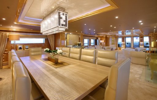 dining area with lounge beyond in main salon of luxury yacht ‘Lady Luck’ 