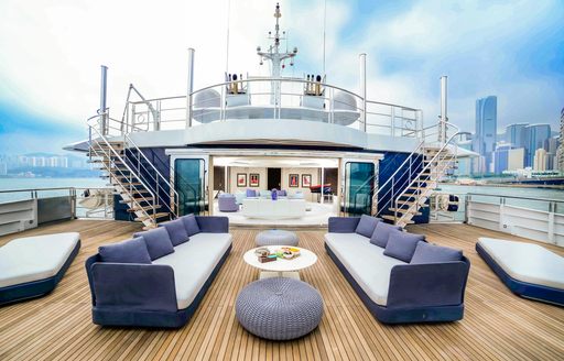 bridge deck with lounging and steps up to sun deck on luxury yacht SALUZI