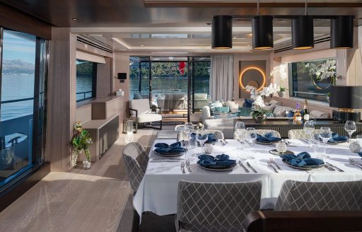Interior dining area onboard charter yacht MOWANA with lounge in the background