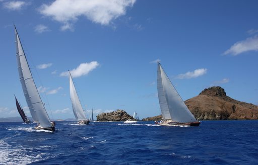 racing sailboats against blue sky