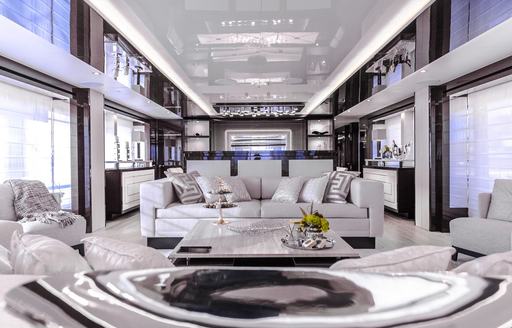 The white furnishings and fixtures located in the main salon of luxury yacht 'Aqua Libra'