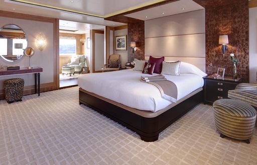 Overview of the master cabin onboard charter yacht LADY BRITT, central berth facing forward with a lounge area to port.