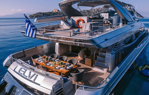Aft view of charter yacht ELVI at sea, with alfresco dining options visible on both exterior decks