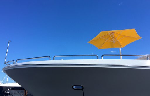 yellow umbrella on the foredeck of a yacht at FLIBS 2017